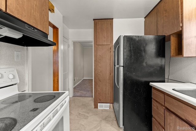 785 Tromley St, Inkster, MI 48141 - kitchen with white electric range, freestanding refrigerator, exhaust hood, brown cabinetry, and light countertops