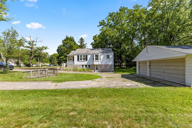 785 Tromley St, Inkster, MI 48141 - view of front of house featuring an outbuilding, a front lawn, and a detached garage