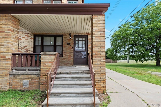 4200 Lois St, Dearborn, MI 48126 - property entrance featuring brick siding, a yard, and covered porch