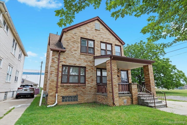 4200 Lois St, Dearborn, MI 48126 - view of front of house with brick siding, a front lawn, and a porch