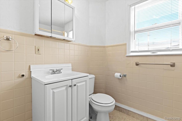 4200 Lois St, Dearborn, MI 48126 - bathroom with tile walls, vanity, tile patterned flooring, and wainscoting