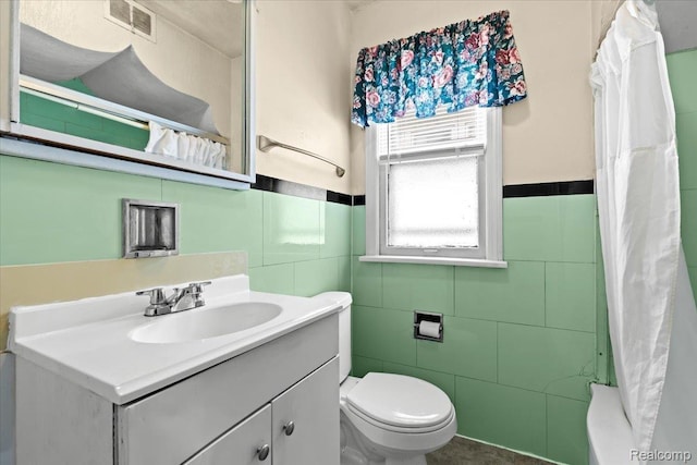 4200 Lois St, Dearborn, MI 48126 - full bathroom with tile walls, vanity, a wainscoted wall, and shower / tub combo