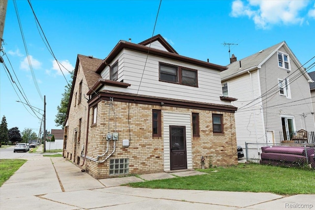 4200 Lois St, Dearborn, MI 48126 - rear view of property featuring brick siding and concrete driveway