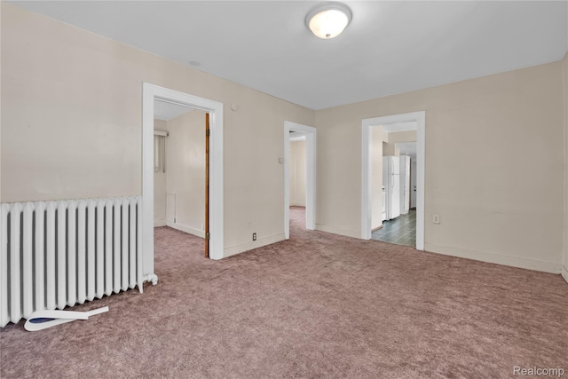 2147 Romeo St, Ferndale, MI 48220 - empty room featuring radiator heating unit and carpet floors