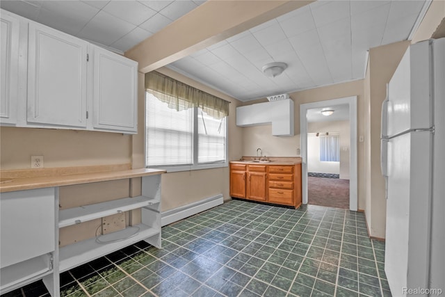 2147 Romeo St, Ferndale, MI 48220 - kitchen featuring freestanding refrigerator, a baseboard heating unit, light countertops, and white cabinetry