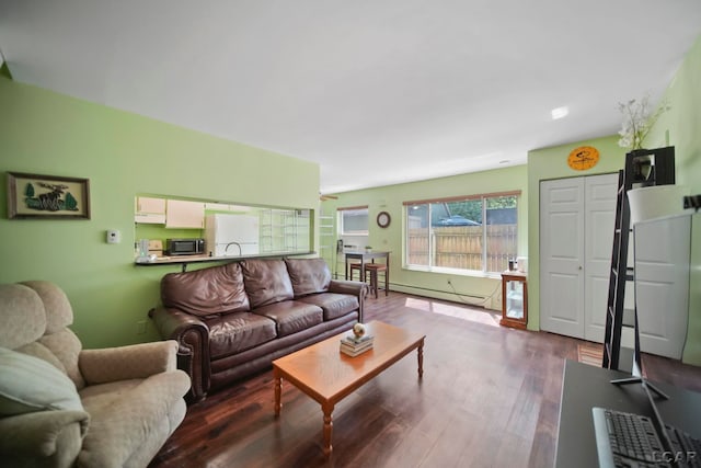 317 Clark St, Clinton, MI 49236 - living area with baseboard heating and wood finished floors