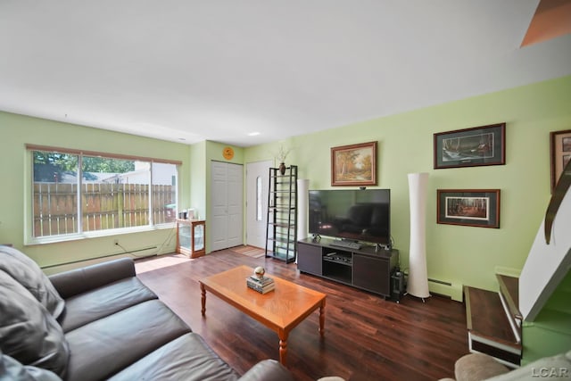 317 Clark St, Clinton, MI 49236 - living area with dark wood-type flooring and a baseboard heating unit
