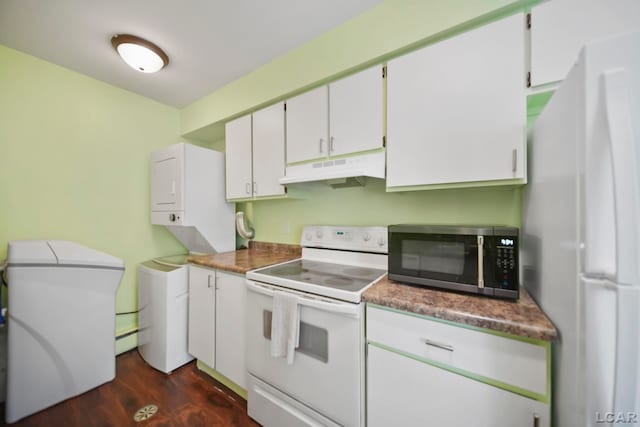 317 Clark St, Clinton, MI 49236 - kitchen with white appliances, under cabinet range hood, stacked washing machine and dryer, dark wood-style flooring, and white cabinetry