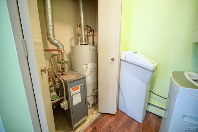 317 Clark St, Clinton, MI 49236 - laundry area with gas water heater, wood finished floors, and washer / clothes dryer