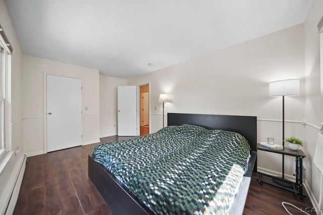 317 Clark St, Clinton, MI 49236 - bedroom featuring a baseboard heating unit and wood finished floors