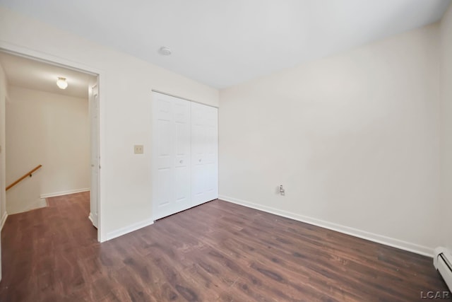 317 Clark St, Clinton, MI 49236 - unfurnished bedroom with baseboard heating, wood finished floors, and a closet