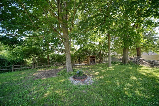 317 Clark St, Clinton, MI 49236 - fenced backyard featuring view of wooded area