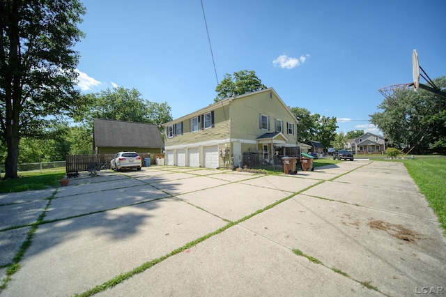 317 Clark St, Clinton, MI 49236 - view of side of property with a garage and driveway