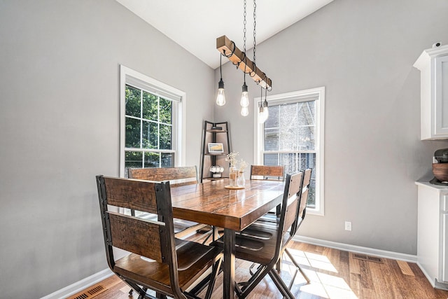 3457 Easy St, Saint Joseph, MI 49085 - dining room with light wood-type flooring and vaulted ceiling