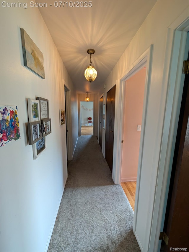 1391 Dye Krest Cir, Flint, MI 48532 - hall featuring carpet and a chandelier