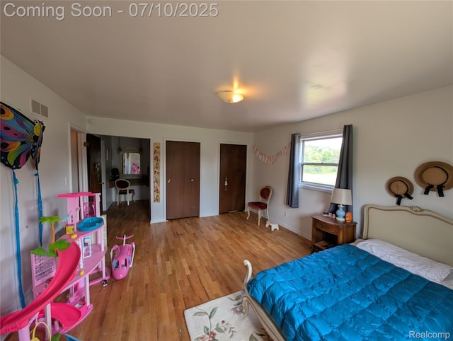 1391 Dye Krest Cir, Flint, MI 48532 - bedroom with wood finished floors and multiple closets