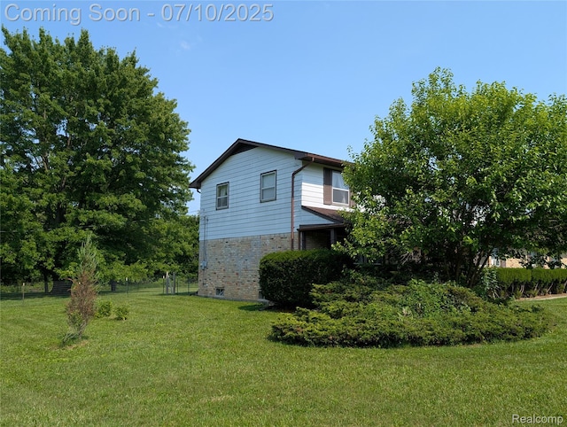 1391 Dye Krest Cir, Flint, MI 48532 - view of side of home with brick siding and a lawn