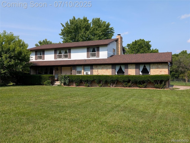 1391 Dye Krest Cir, Flint, MI 48532 - view of front of home with a chimney, a front yard, and brick siding