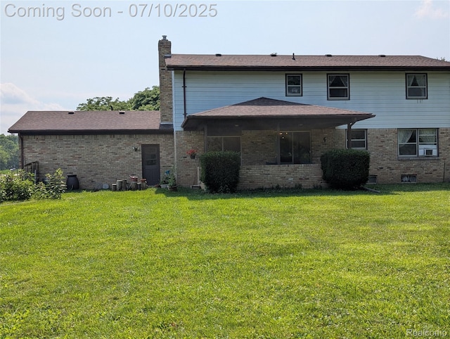 1391 Dye Krest Cir, Flint, MI 48532 - back of house with brick siding, a chimney, and a lawn