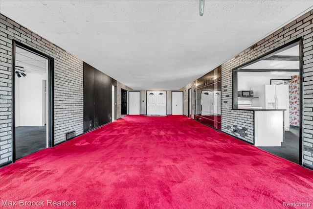 2840 Wall St, Keego Harbor, MI 48320 - carpeted spare room with brick wall