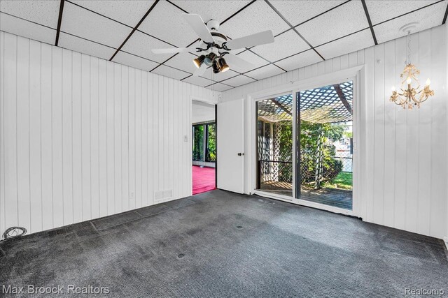 2840 Wall St, Keego Harbor, MI 48320 - carpeted spare room with plenty of natural light, a ceiling fan, a drop ceiling, a chandelier, and wood walls