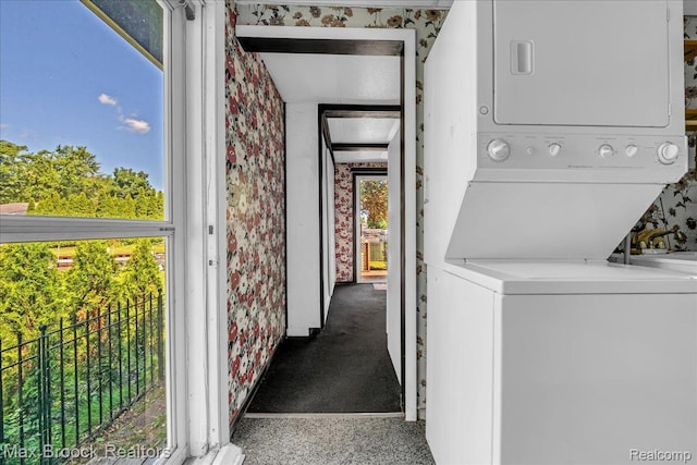 2840 Wall St, Keego Harbor, MI 48320 - laundry area featuring stacked washer and clothes dryer and wallpapered walls