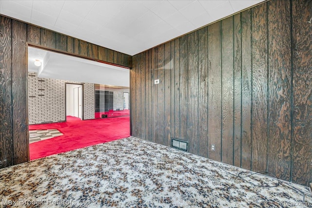 2840 Wall St, Keego Harbor, MI 48320 - unfurnished bedroom featuring carpet and wooden walls