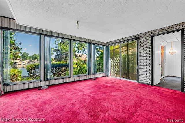 2840 Wall St, Keego Harbor, MI 48320 - unfurnished sunroom featuring plenty of natural light, a water view, and a chandelier