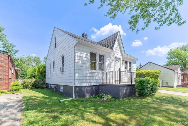20892 Dean St, Warren, MI 48091 - view of home's exterior featuring a chimney, a yard, cooling unit, and a shingled roof
