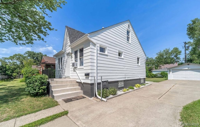 20892 Dean St, Warren, MI 48091 - view of property exterior with an outbuilding, a garage, a lawn, and roof with shingles