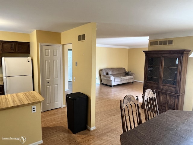 13939 Harrington Dr, Warren, MI 48088 - dining space featuring light wood-style floors and ornamental molding