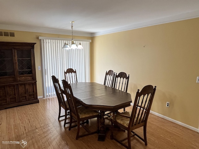13939 Harrington Dr, Warren, MI 48088 - dining room with light wood-type flooring, a chandelier, and ornamental molding