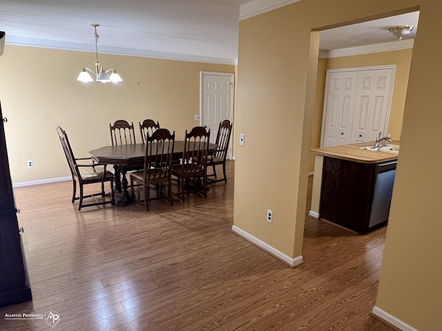 13939 Harrington Dr, Warren, MI 48088 - dining area with crown molding, wood finished floors, and a chandelier
