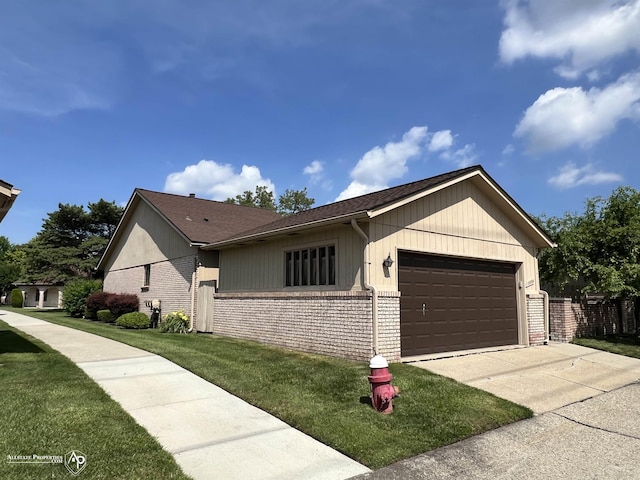 13939 Harrington Dr, Warren, MI 48088 - view of front of property featuring an attached garage, brick siding, a front yard, and driveway