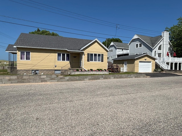 15 Lakeshore Dr, Manistee, MI 49660 - view of front of house with an outbuilding, crawl space, and a garage