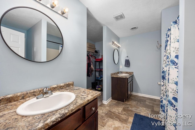 1698 Trent Ridge Ct NE, Cedar Springs, MI 49319 - full bath featuring vanity, a textured ceiling, a walk in closet, stone finish flooring, and a shower with curtain