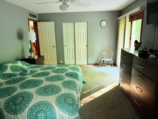 11585 190th Ave, Big Rapids, MI 49307 - bedroom featuring dark carpet, a textured ceiling, a closet, and a ceiling fan