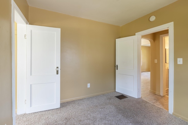 1234 Diamond Ave NE, Grand Rapids, MI 49505 - unfurnished bedroom featuring arched walkways and carpet floors