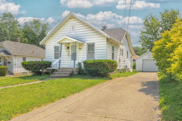 1234 Diamond Ave NE, Grand Rapids, MI 49505 - view of front of property with an outbuilding, driveway, a detached garage, and a front yard