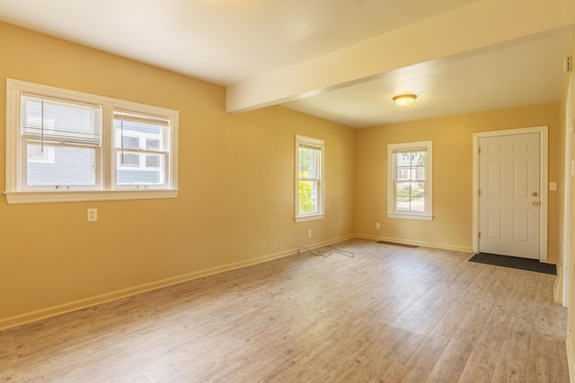 1234 Diamond Ave NE, Grand Rapids, MI 49505 - empty room featuring light wood-style floors and beam ceiling