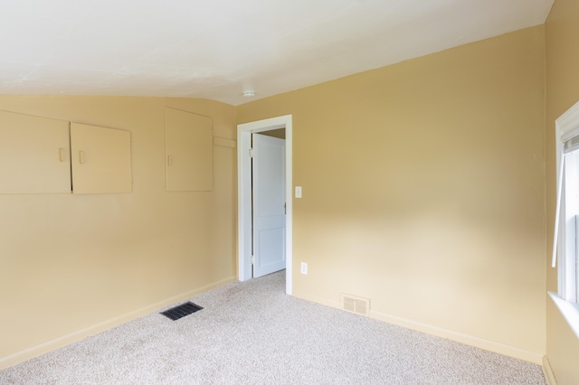 1234 Diamond Ave NE, Grand Rapids, MI 49505 - unfurnished room featuring carpet floors, vaulted ceiling, and a smoke detector