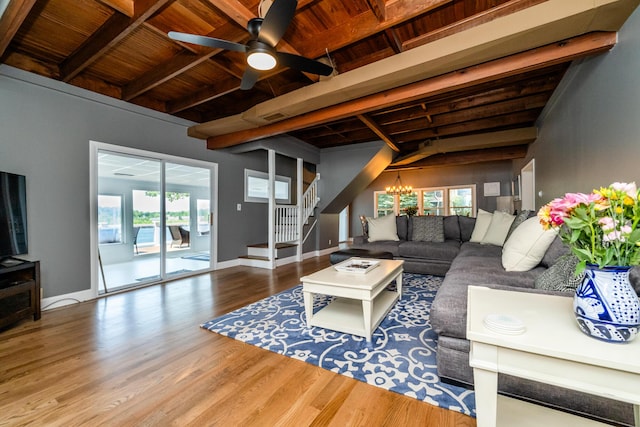 5680 Woodland Ave, Watervliet, MI 49098 - living room with a wooden ceiling with exposed beams, wood finished floors, healthy amount of natural light, stairs, and a chandelier