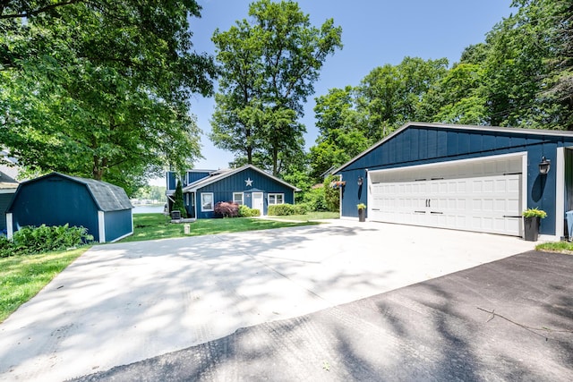 5680 Woodland Ave, Watervliet, MI 49098 - view of front of house with a garage, a shed, and a front lawn