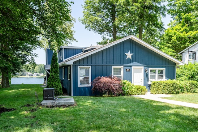 5680 Woodland Ave, Watervliet, MI 49098 - bungalow featuring a front lawn, a water view, and board and batten siding