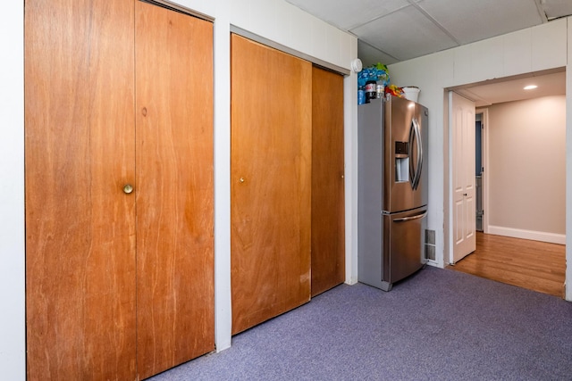 5680 Woodland Ave, Watervliet, MI 49098 - unfurnished bedroom with stainless steel fridge with ice dispenser, multiple closets, and carpet