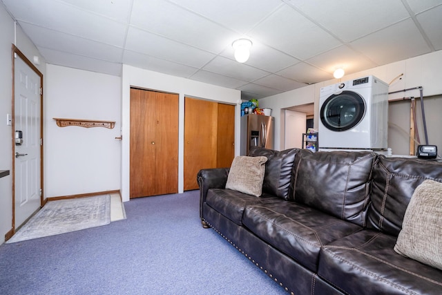 5680 Woodland Ave, Watervliet, MI 49098 - carpeted living area with stacked washer and clothes dryer and a drop ceiling