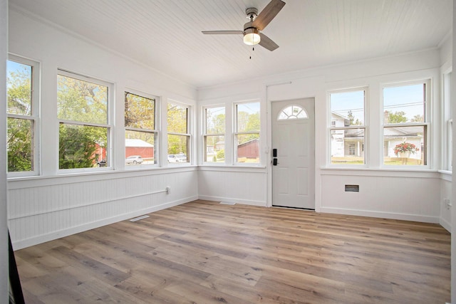 22121 Bedford Rd N, Battle Creek, MI 49017 - unfurnished sunroom with a deck, wood finished floors, and crown molding