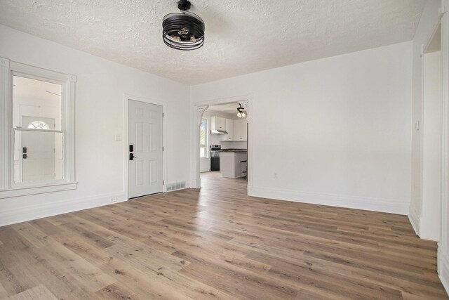 22121 Bedford Rd N, Battle Creek, MI 49017 - empty room featuring wood finished floors and a textured ceiling