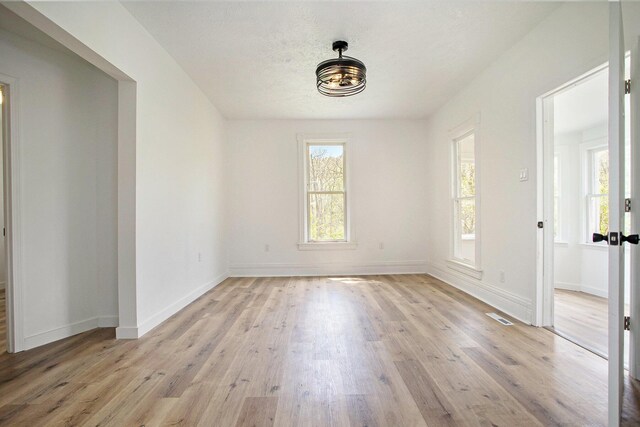 22121 Bedford Rd N, Battle Creek, MI 49017 - unfurnished room with light wood-style floors and baseboards