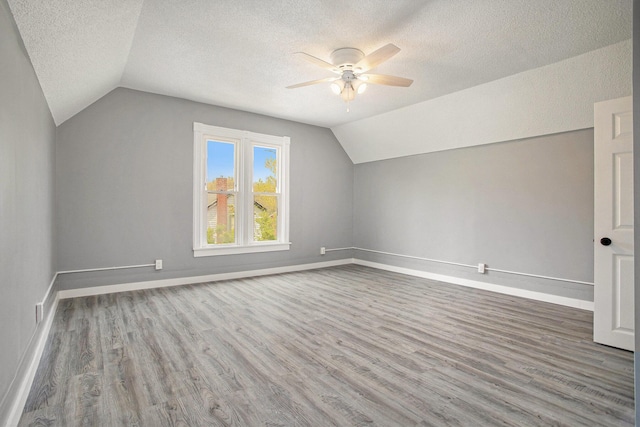 22121 Bedford Rd N, Battle Creek, MI 49017 - bonus room with ceiling fan, vaulted ceiling, a textured ceiling, and wood finished floors